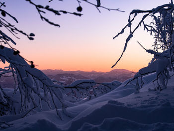 Scenic view of snow covered mountains against sky during sunrise