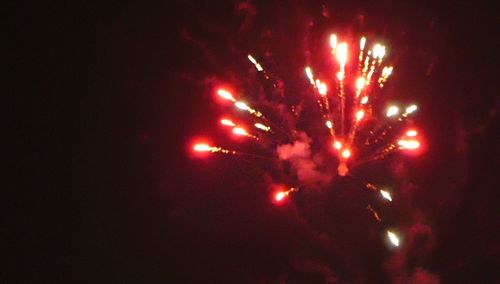 Low angle view of firework display at night