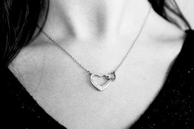 Close-up of woman with heart shape pendant in necklace