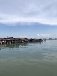 Built structure by sea against sky