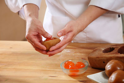 Close-up of man preparing food on cutting board