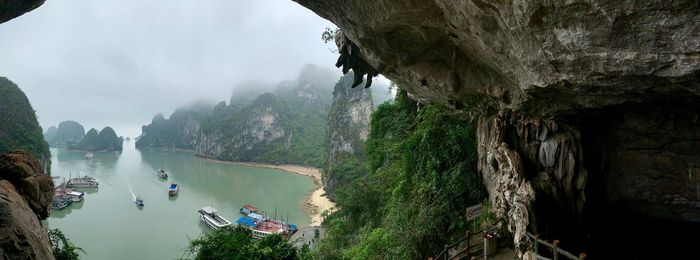 Scenic view of lake and mountains seen through cave