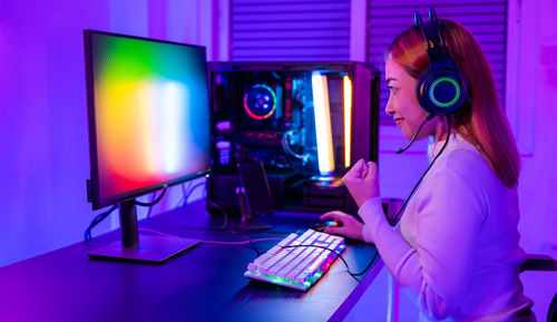 Young woman using laptop at table