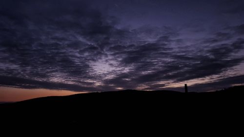 Silhouette landscape against sky at sunset