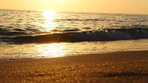 View of calm beach at sunset