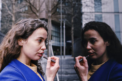 Portrait of young man looking through window