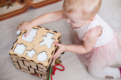 High angle view of cute boy with toy blocks on table