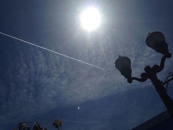 Low angle view of silhouette trees against sky