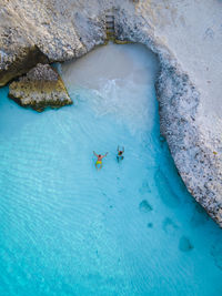 High angle view of people swimming in sea