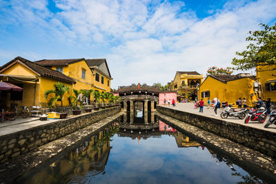 Hoian bridge temple - reflection of buildings in water