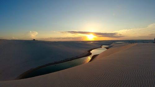 Scenic view of desert against sky during sunset