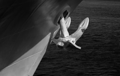 Low angle view of man in mid-air by sea against sky