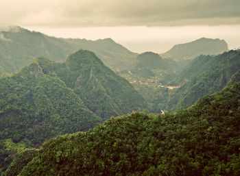 Scenic view of mountains against cloudy sky