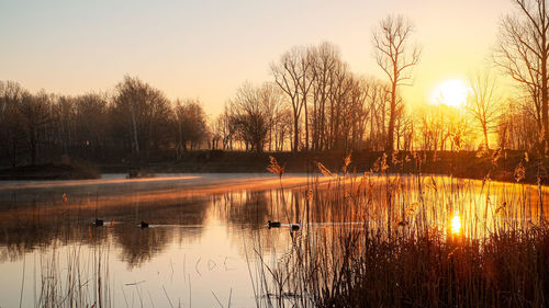 Scenic view of lake against sky during sunset