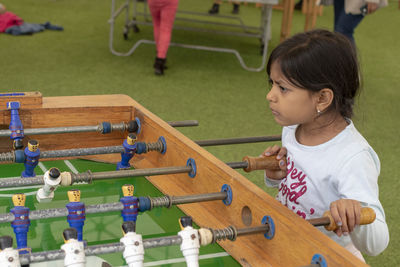 Cute girl playing foosball 