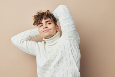 Smiling man against beige background