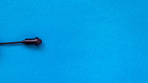 High angle view of electric lamp against blue background