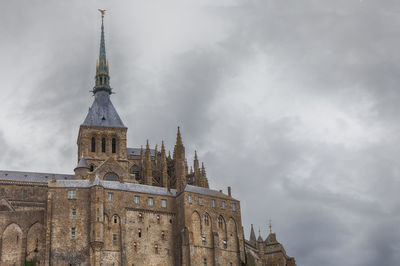 Low angle view of cathedral against cloudy sky