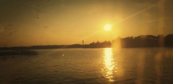 Scenic view of lake against sky during sunset