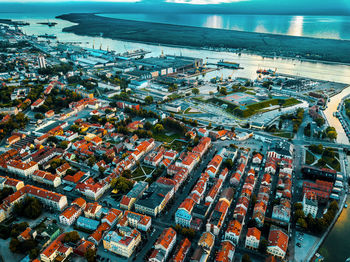 High angle view of buildings by sea in city