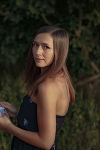 Side view portrait of woman standing on field