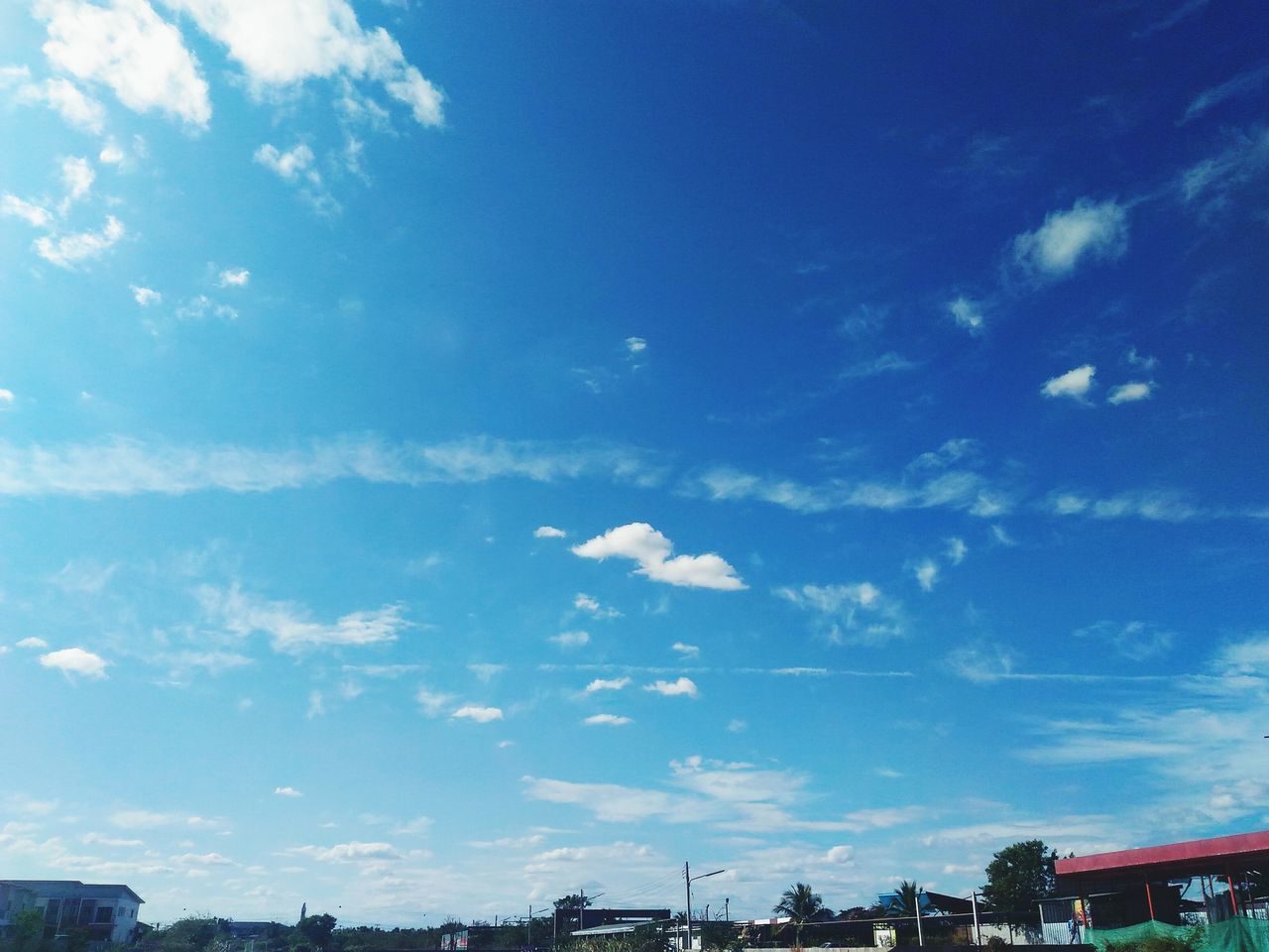 sky, blue, building exterior, built structure, architecture, cloud - sky, low angle view, cloud, city, sunlight, outdoors, day, nature, no people, building, car, transportation, residential building, residential structure, cloudy