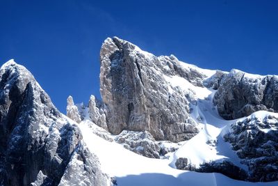 Scenic view of snowcapped mountains against clear blue sky