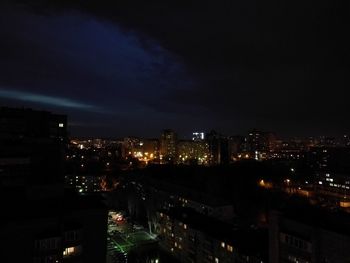 Illuminated cityscape against sky at night