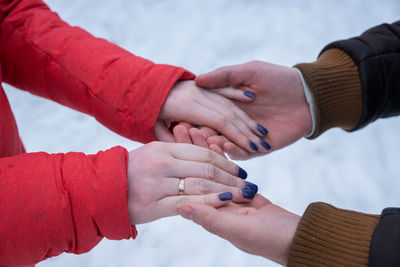 Midsection of couple holding hands