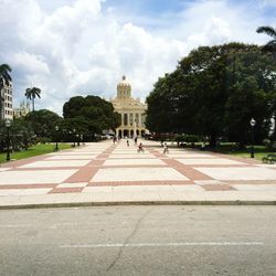 Tourists walking on sidewalk