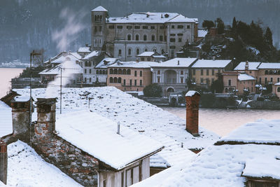 Snow covered buildings in city