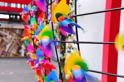 Colorful pinwheel toys hanging on railing