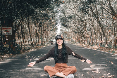 Portrait of woman sitting in forest
