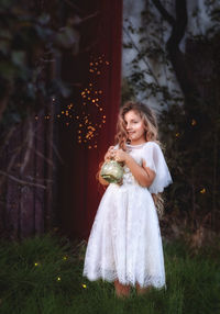 Girl standing against plants