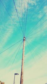 Low angle view of power lines against blue sky