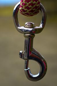 Close-up of camera hanging on metal
