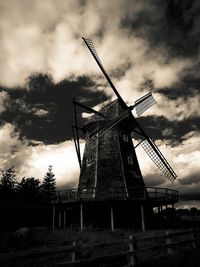 Low angle view of wind turbine in field