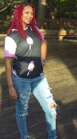 Portrait of smiling young woman standing outdoors