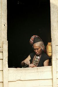 Portrait of a young woman sitting on bench