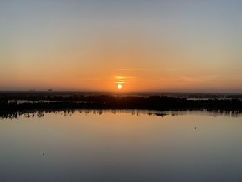 Scenic view of lake against sky during sunset