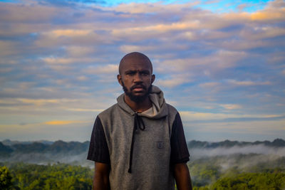 Portrait of man standing against sky during sunset