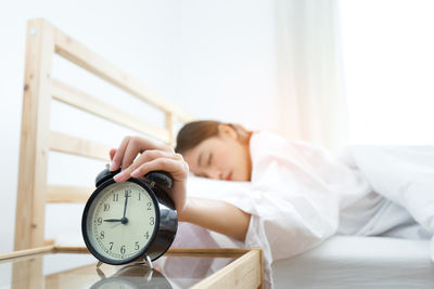 Woman sleeping on bed at home