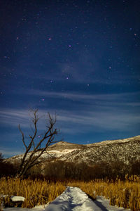 Scenic view of mountains against sky at night