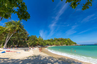 Scenic view of beach against blue sky