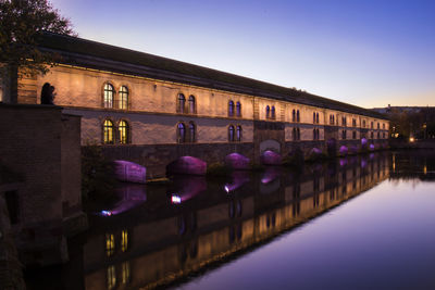 Reflection of building in water at night