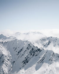 Scenic view of snowcapped mountains against clear sky