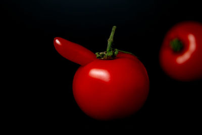 Close-up of red bell peppers against black background