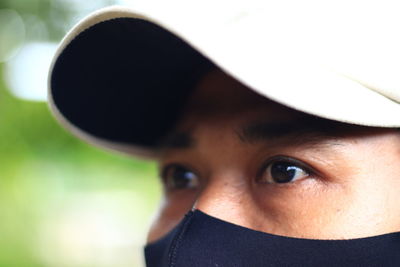 Close-up portrait of young man wearing hat