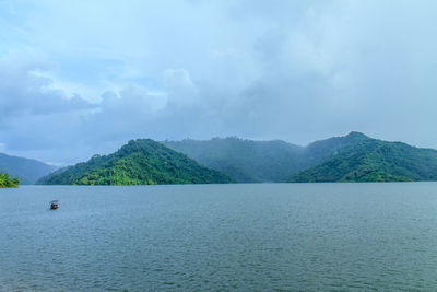 Scenic view of sea and mountains against sky