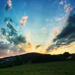 Scenic view of field against sky during sunset